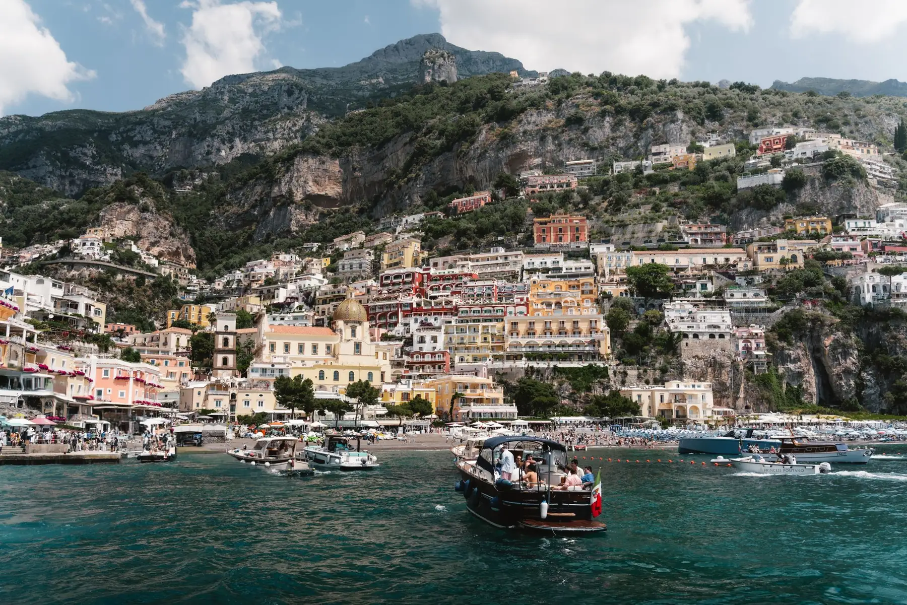 Colorful houses of Positano stacked on cliffs above the sea.